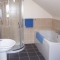 Ensuite bathroom with whirlpool spa bath in Maggie's Mews at Greetham Retreat