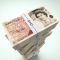 Stack Of British Money with Cuts Symbol on Money Ties