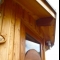 The roof eaves - overhang of over 40cm- solid Douglas Fir beams and British Larch Boarding