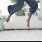 woman-jumping-on-new-carpet-min
